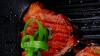 Grilled beef fillet strips on grill teflon black plate over wood 1920x1080 intro motion slow hidef hd