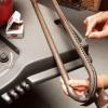 Tune up your gas grill by cleaning the grates, the burners, the drip pans and the exterior to remove caked on grease that interferes with starting and cooking.