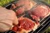Turning steak cooking on a charcoal grill