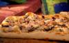 Greek pizza with chicken feta and olives with mixed cherry tomato salad