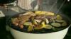 Opening kettle barbecue grill in garden